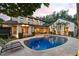 Stunning exterior view of a home with a sparkling pool and landscaped backyard at dusk at 141 S Phelps Ave, Winter Park, FL 32789