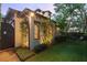 Side exterior with lush greenery, a swing and charming architecture details at 141 S Phelps Ave, Winter Park, FL 32789