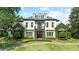 Elegant two-story home with manicured lawn, charming ivy, and a welcoming entrance at 141 S Phelps Ave, Winter Park, FL 32789
