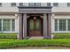 Detailed front entrance showcasing ornate double doors, columns, and manicured landscaping at 141 S Phelps Ave, Winter Park, FL 32789