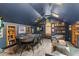 Spacious game room featuring a poker table, built-in shelving, ample seating and stylish decor at 141 S Phelps Ave, Winter Park, FL 32789