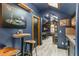 Game room features blue walls, wood-look floors, a small bar area, and room for table games at 141 S Phelps Ave, Winter Park, FL 32789
