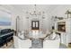 Inviting living room features fireplace, piano, elegant chandelier and comfortable seating at 141 S Phelps Ave, Winter Park, FL 32789