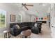 Open living room includes a large sectional sofa, coffered ceiling, and stylish decor at 141 S Phelps Ave, Winter Park, FL 32789