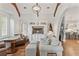 Living room with high ceilings, fireplace, hardwood floors, large window, and adjacent bar and kitchen area at 141 S Phelps Ave, Winter Park, FL 32789
