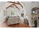 Living room with vaulted ceilings, hardwood floors, fireplace, built-in shelving, and window with shutters at 141 S Phelps Ave, Winter Park, FL 32789