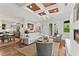 Bright living room with fireplace, hardwood floors, coffered ceiling, and access to kitchen and outdoor patio at 141 S Phelps Ave, Winter Park, FL 32789