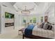Inviting main bedroom with a cozy sitting area, fireplace, and a large television at 141 S Phelps Ave, Winter Park, FL 32789