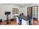 Office features a large desk, wood floors, clerestory window, and exercise equipment at 141 S Phelps Ave, Winter Park, FL 32789