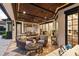 Expansive outdoor living area with wood ceiling, stainless steel grill, and comfortable seating at 141 S Phelps Ave, Winter Park, FL 32789