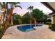 Inviting pool area with lush landscaping, palm trees, and a relaxing atmosphere at 141 S Phelps Ave, Winter Park, FL 32789