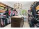 Spacious walk-in closet with custom shelving, drawers, and a stylish chandelier at 141 S Phelps Ave, Winter Park, FL 32789