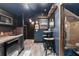 Well-equipped wet bar with modern appliances, bar seating, and access to a luxurious bathroom at 141 S Phelps Ave, Winter Park, FL 32789