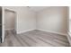 Neutral bedroom with grey laminate flooring, an open door, and a window at 14244 Walcott Ave, Orlando, FL 32827