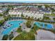 Overhead view of the community pool area featuring multiple pools, a volleyball court, and lounge chairs at 14244 Walcott Ave, Orlando, FL 32827