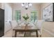 Cozy dining area with modern chandelier and seating for four creates a perfect spot for meals at 14244 Walcott Ave, Orlando, FL 32827
