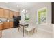 Bright dining area features tile floors, modern chandelier, and a table set for four guests at 14244 Walcott Ave, Orlando, FL 32827