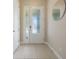 Bright entryway featuring a white door with sidelight and tile flooring at 14244 Walcott Ave, Orlando, FL 32827
