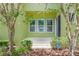 Inviting light green front porch with a home security system sign and lush landscaping at 14244 Walcott Ave, Orlando, FL 32827