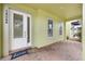 Charming covered porch features brick flooring and views to the neighborhood at 14244 Walcott Ave, Orlando, FL 32827
