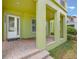 A spacious front porch with brick flooring, architectural columns, and a welcoming entrance at 14244 Walcott Ave, Orlando, FL 32827