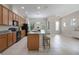 Spacious kitchen island featuring granite countertops, bar stool seating, and natural wood cabinets at 14244 Walcott Ave, Orlando, FL 32827