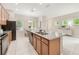 Kitchen island featuring a double sink, granite countertops, and views into the dining area at 14244 Walcott Ave, Orlando, FL 32827