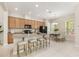 Large kitchen island with seating overlooks the open concept dining area and plenty of cabinets at 14244 Walcott Ave, Orlando, FL 32827