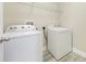 Bright laundry room features modern appliances, including a Whirlpool washer and dryer, and convenient overhead shelving at 14244 Walcott Ave, Orlando, FL 32827