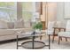 Well-lit living room showcasing a comfortable sofa, stylish chairs, and a chic coffee table at 14244 Walcott Ave, Orlando, FL 32827