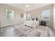 Spacious main bedroom with bright windows, a ceiling fan and light gray wood-look floors at 14244 Walcott Ave, Orlando, FL 32827
