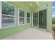 Relax on this light green patio featuring concrete floors, sliding doors and multiple windows at 14244 Walcott Ave, Orlando, FL 32827