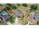 Overhead view of the property featuring lush landscaping, private pools, and the surrounding neighborhood at 144 Henue Ct, Davenport, FL 33896
