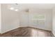 Vacant room featuring neutral paint, hardwood floors, and a large window at 144 Henue Ct, Davenport, FL 33896