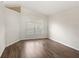 Empty bedroom featuring neutral paint, hardwood floors, and a large window at 144 Henue Ct, Davenport, FL 33896