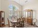 Elegant dining area with a large window, chandelier, and traditional wood furniture at 144 Henue Ct, Davenport, FL 33896