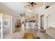 Open-concept living space connecting the kitchen, dining area, and outdoor patio at 144 Henue Ct, Davenport, FL 33896
