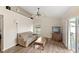 Living room with a ceiling fan, hardwood floors, a comfy sofa, and a backyard view at 144 Henue Ct, Davenport, FL 33896