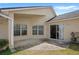 Covered patio featuring a concrete floor and views of the lush backyard and surrounding landscape at 144 Henue Ct, Davenport, FL 33896