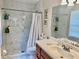 Modern bathroom with white marble walls, glass shower door, and updated sink and fixtures at 1449 Amanda Rd, Kissimmee, FL 34744