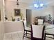 The dining area has a glass table, white chairs, and decorative plants, flowing into the living room at 1449 Amanda Rd, Kissimmee, FL 34744