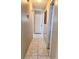 Neutral hallway with tile flooring, leading to various rooms within the home at 1449 Amanda Rd, Kissimmee, FL 34744