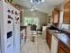 Functional kitchen with wood cabinetry, white appliances, and ample counter space with a cute dog at 1449 Amanda Rd, Kissimmee, FL 34744
