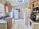 Well-lit kitchen with wood cabinets, modern appliances, and tile flooring offers a practical cooking space at 1449 Amanda Rd, Kissimmee, FL 34744