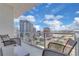 Relaxing balcony seating area with a great view of the surrounding city skyline at 150 E Robinson St # 2002, Orlando, FL 32801