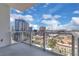 Balcony with glass railings showcasing stunning city views on a sunny day at 150 E Robinson St # 2002, Orlando, FL 32801