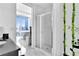 Modern bathroom with glass-enclosed shower and city views at 150 E Robinson St # 2002, Orlando, FL 32801
