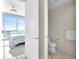 Bedroom view into an adjacent bathroom with toilet and towel rack, plus a city view at 150 E Robinson St # 2002, Orlando, FL 32801