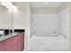 Elegant bathroom featuring a soaking tub with marble surround and a stylish vanity with black countertop at 150 E Robinson St # 2002, Orlando, FL 32801