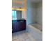 Luxurious bathroom featuring double granite vanity, large soaking tub, and elegant marble finishes at 150 E Robinson St # 2002, Orlando, FL 32801
